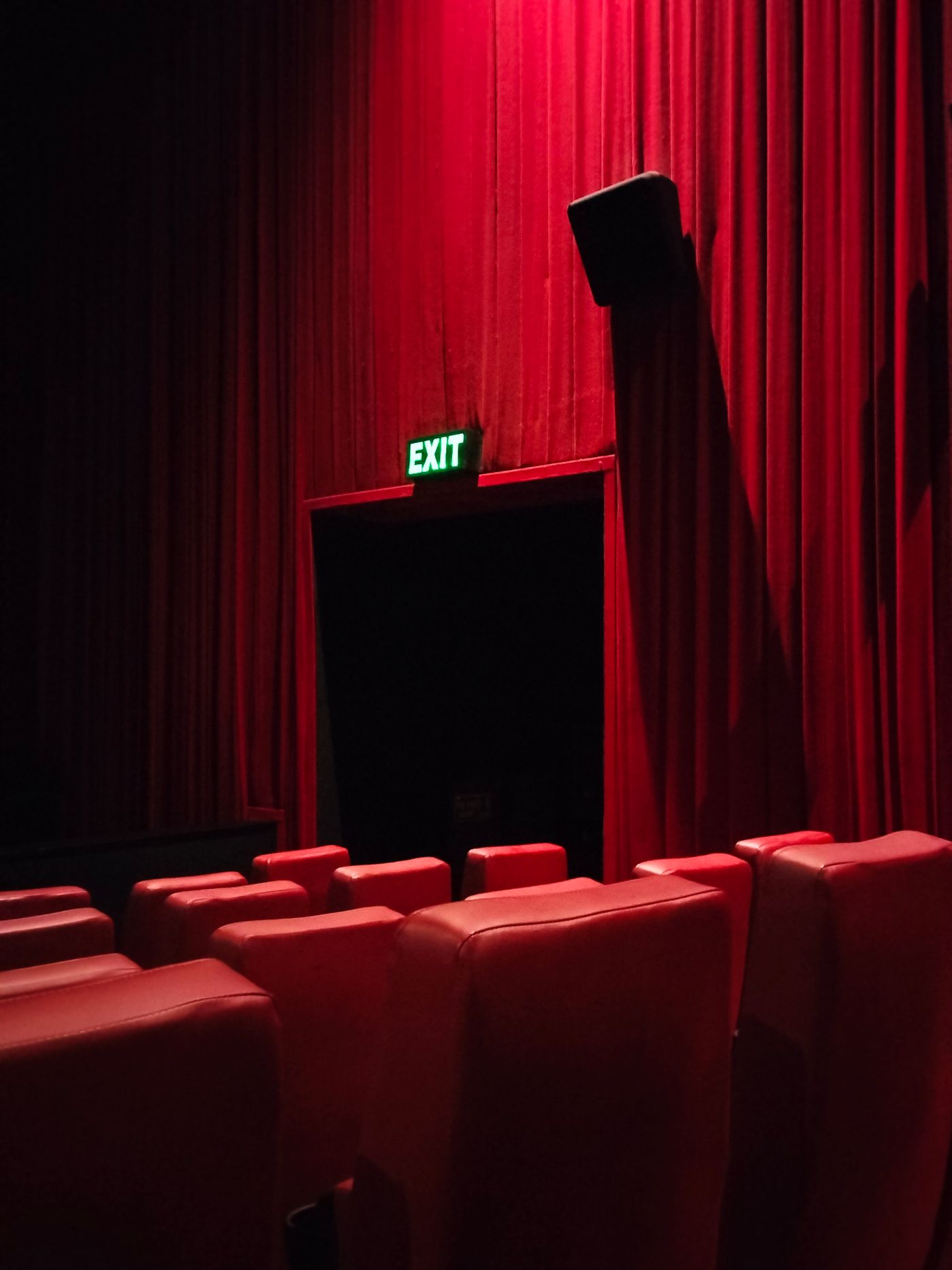 Moody red cinema interior and exit light