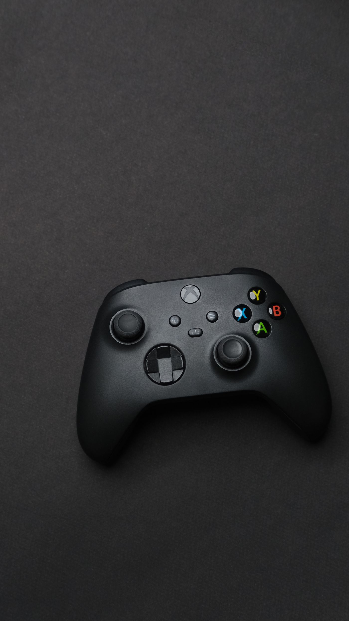 Dark gaming controller on a black background